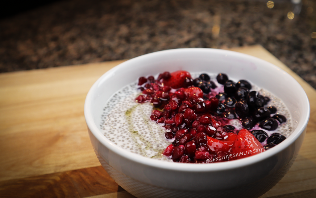 photo of creamy chia pudding topped with blueberries, strawberries and pomegranate