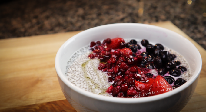 photo of creamy chia pudding topped with blueberries, strawberries and pomegranate
